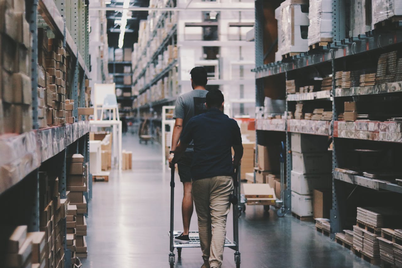 a man pushing a cart in a warehouse